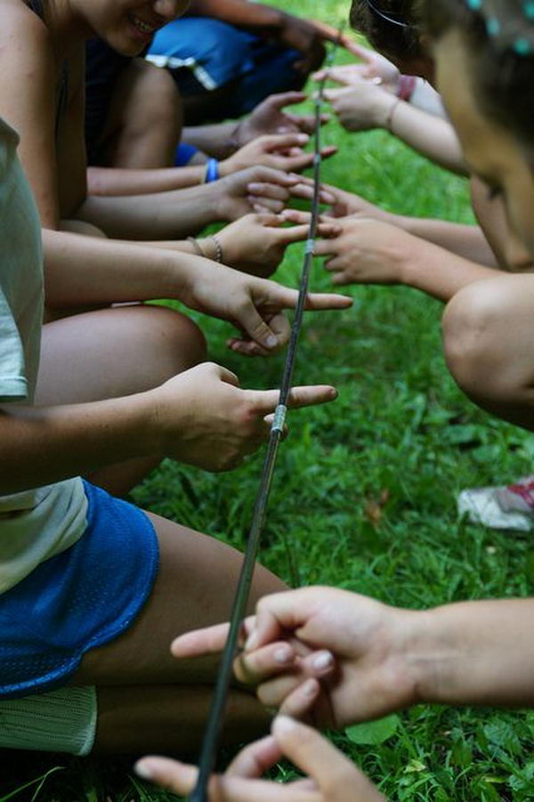 Tent Pole Game Team Building Activities. Great Activity to do with older kids. Everyone in the group has to keep 2 fingers on the tent pole at all times. The goal is to bring the pole off the ground to a certain height without anyone taking their fingers off the pole. (Could go from a certain height then to the ground.) If someone's finger comes off, the group must re start. 