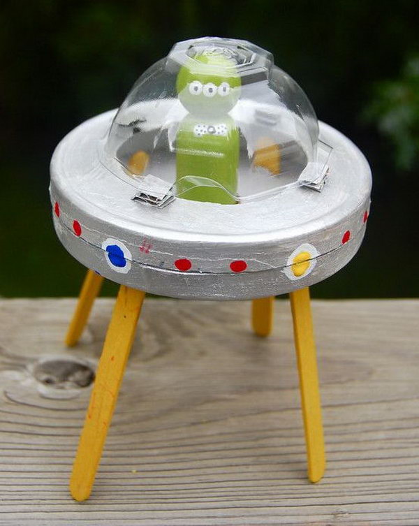Use circular cream cheese box and popsicle sticks to create this alien and cardboard spaceship craft. 