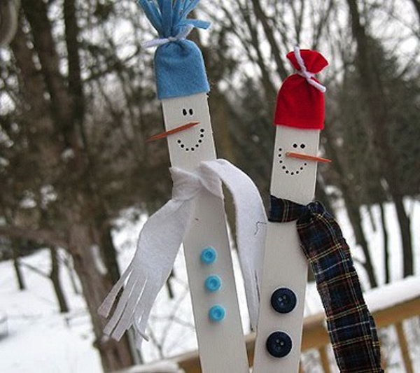 Use paint, buttons and fabric scraps to turn painted wooden sticks into winter characters, 