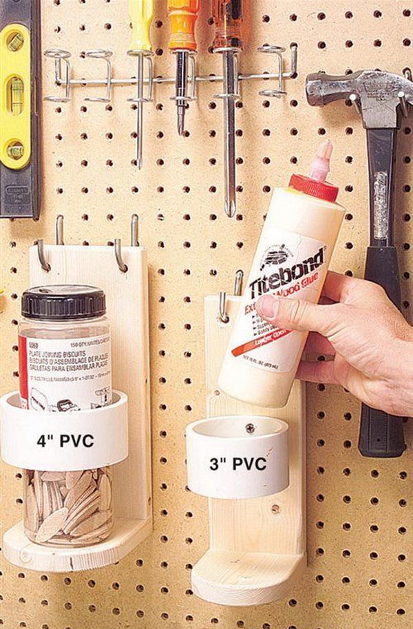 PVC pipe and wood bracket mounted to pegboard for garage storage. 