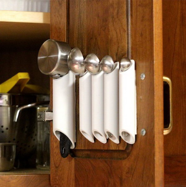 PVC Pipe Kitchen Organizing. DIY kitchen storage solution inside cabinet doors for hanging spoon sets. 