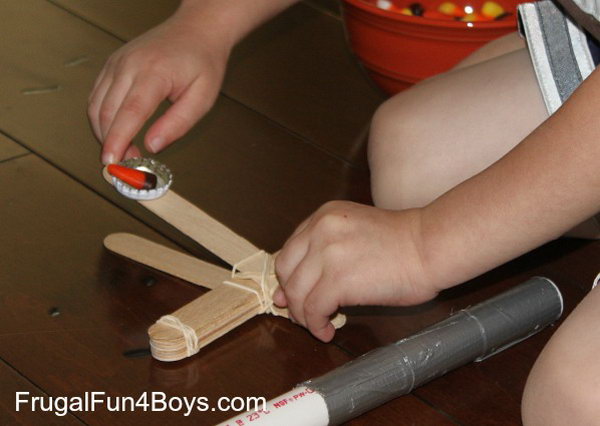 Craft Stick Catapult. This is the best design for young kids.It is built with a bottle cap,which is definitely easier for little hands to shoot. 