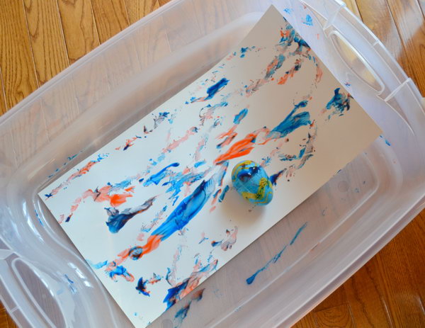 Artistic Easter Egg Roll. Place the colorfully painted Easter egg in a plastic box with paper taped at the bottom. Get the artistic  Easter egg roll painting by tipping the box in various directions. 