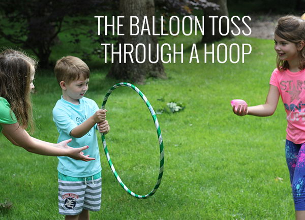 Balloon Toss through a Hoop. Ask one kid to hold the hula hoop and the other kid try to toss the water balloon through the hoop. It's challenging yet interesting. 