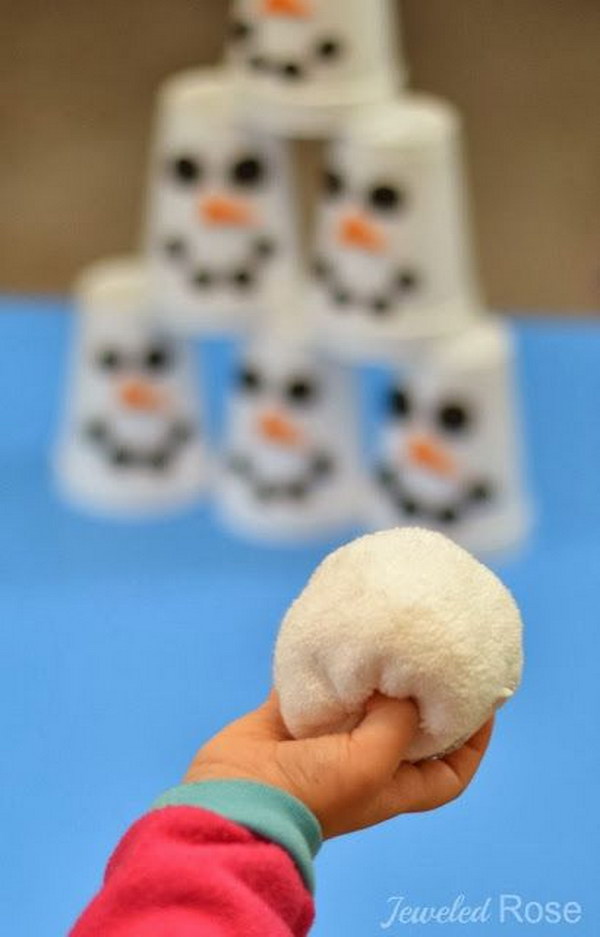 Decorate six white cups using black and orange craft foam. Make the snowballs with white socks. Then the kids can play 'Snowman Slam'. 