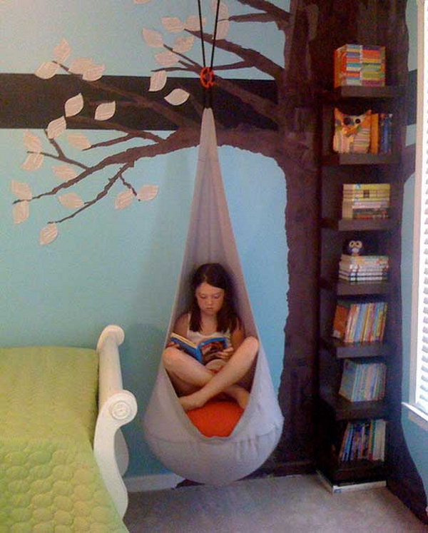 Reading Nook With Cocoon Hanging from the Book Shelf Designed like a Tree 